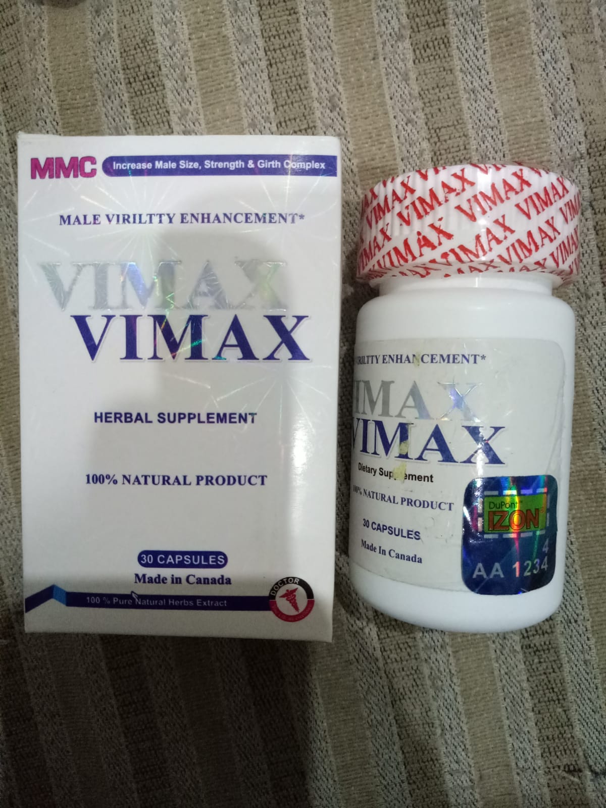 Vimax herbal supplement packaging and bottle on a textured surface